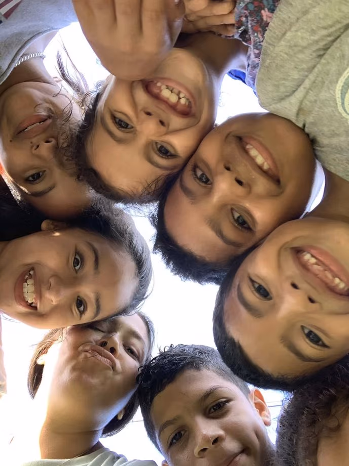Children of Casa Mi Hogar putting their heads together